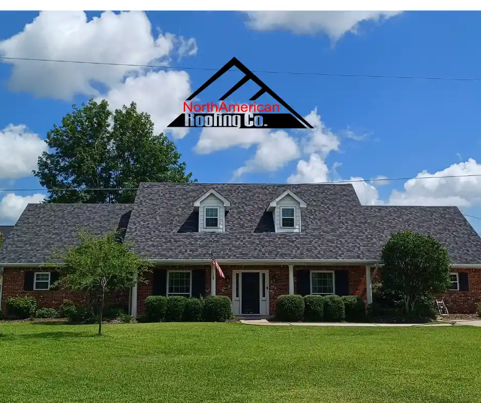 2023-08-20 alt="roofing company near me and beautiful roof gray asphalt with blue sky and green grass)