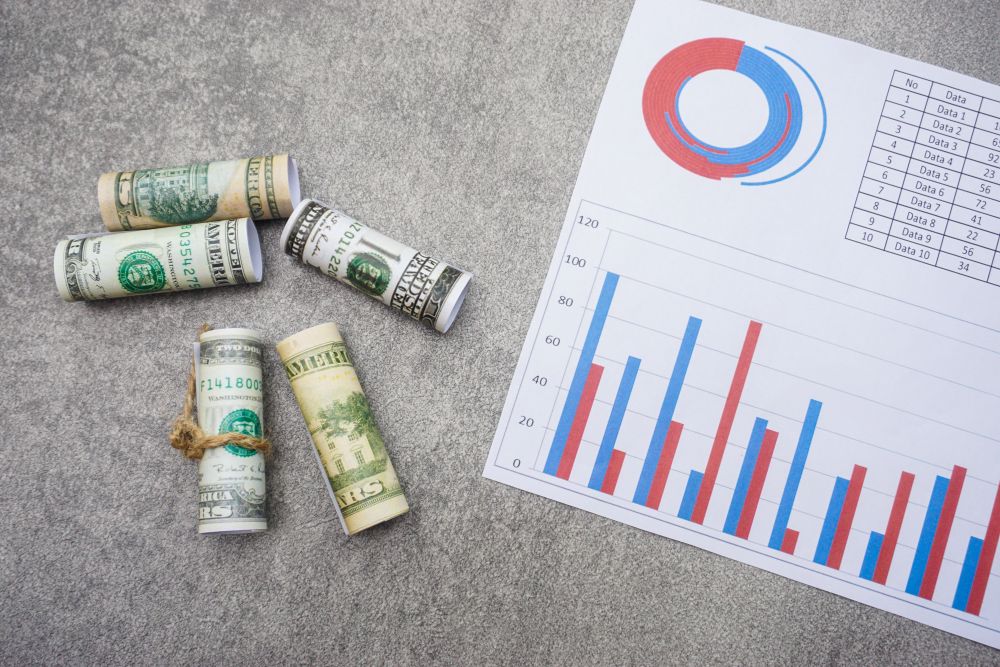 flat-lay-of-rolled-dollar-bills-and-a-paper-with-c-2025-02-09-19-57-28-utc