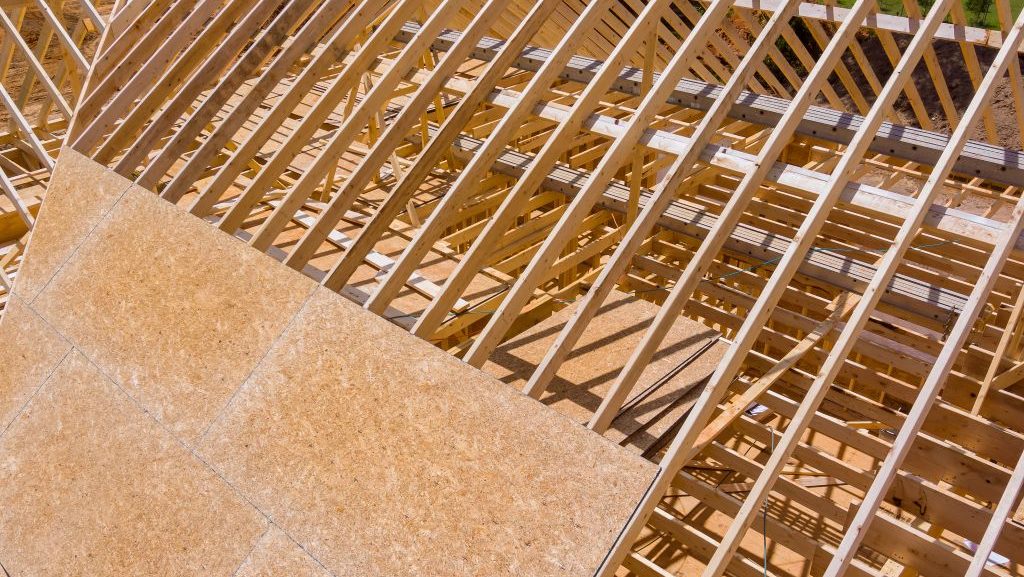 wooden-roofing-truss-frame-installation-under-cons-2025-03-27-05-00-30-utc alt="roof decking"