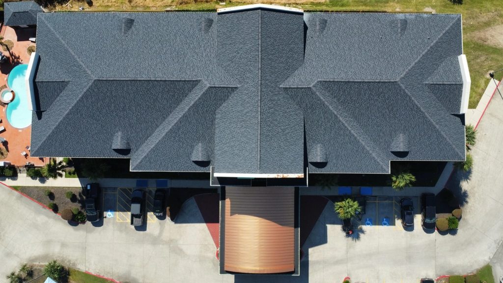 Commercial hotel roof replacement in Spring TX using CertainTeed shingles.