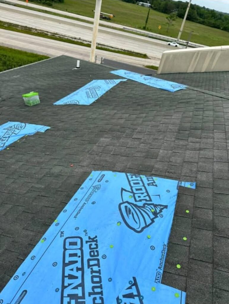 Close-up of a roof tarp secured with furring strips and professional roofing nails in Klein.