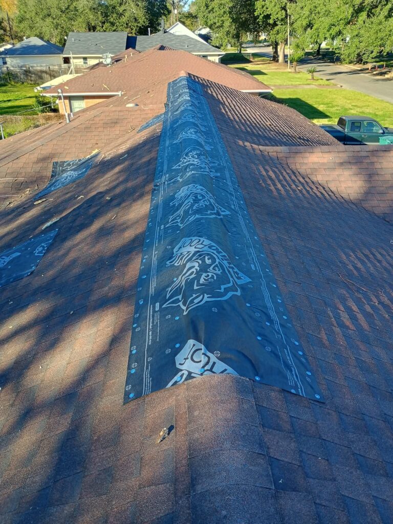 Contractor installing a temporary roof covering following severe wind and hail damage in Spring.