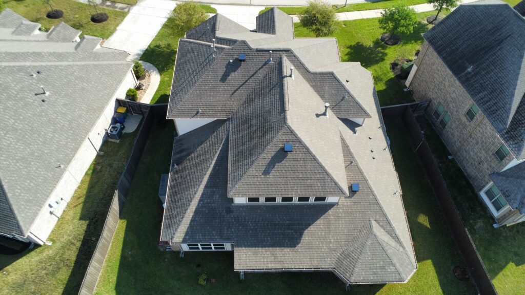 A professional solar powered attic vent installed on a shingle roof in Spring, Texas.