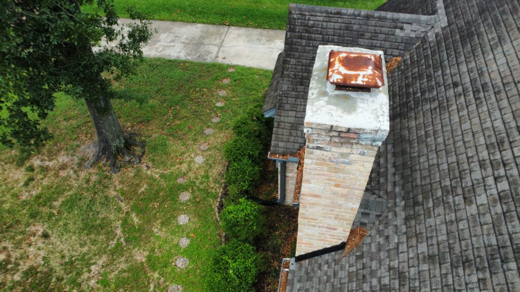 Re-sealing chimney flashing to stop roof leaks in Klein Texas.